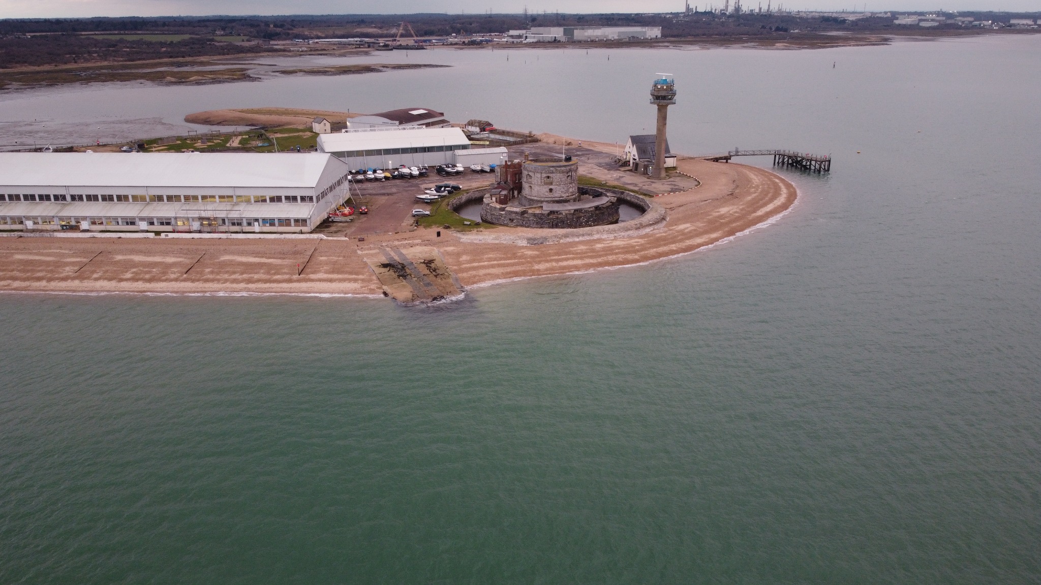 Aerial view of a coastal headland and waterfront buildings